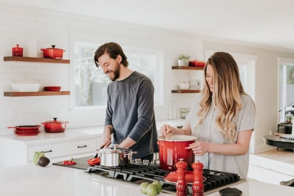 man and woman cooking a holiday meal