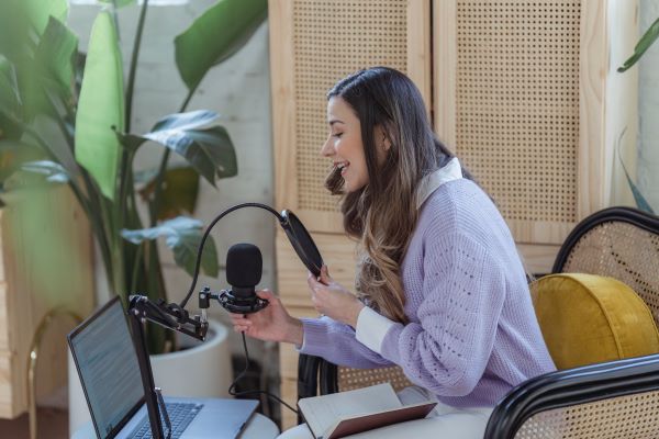 woman speaking into microphone at computer