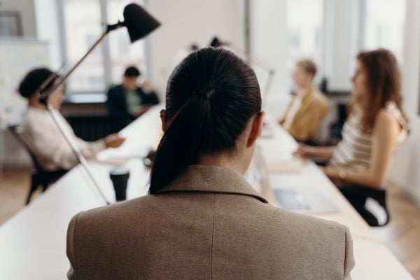 manager sitting at the head of a table