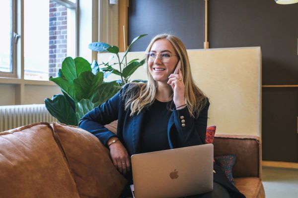 young professional woman taking headhunter phone call
